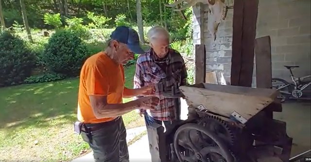 Travis Proctor with Alton Medlin checking out the Apple Cider Press